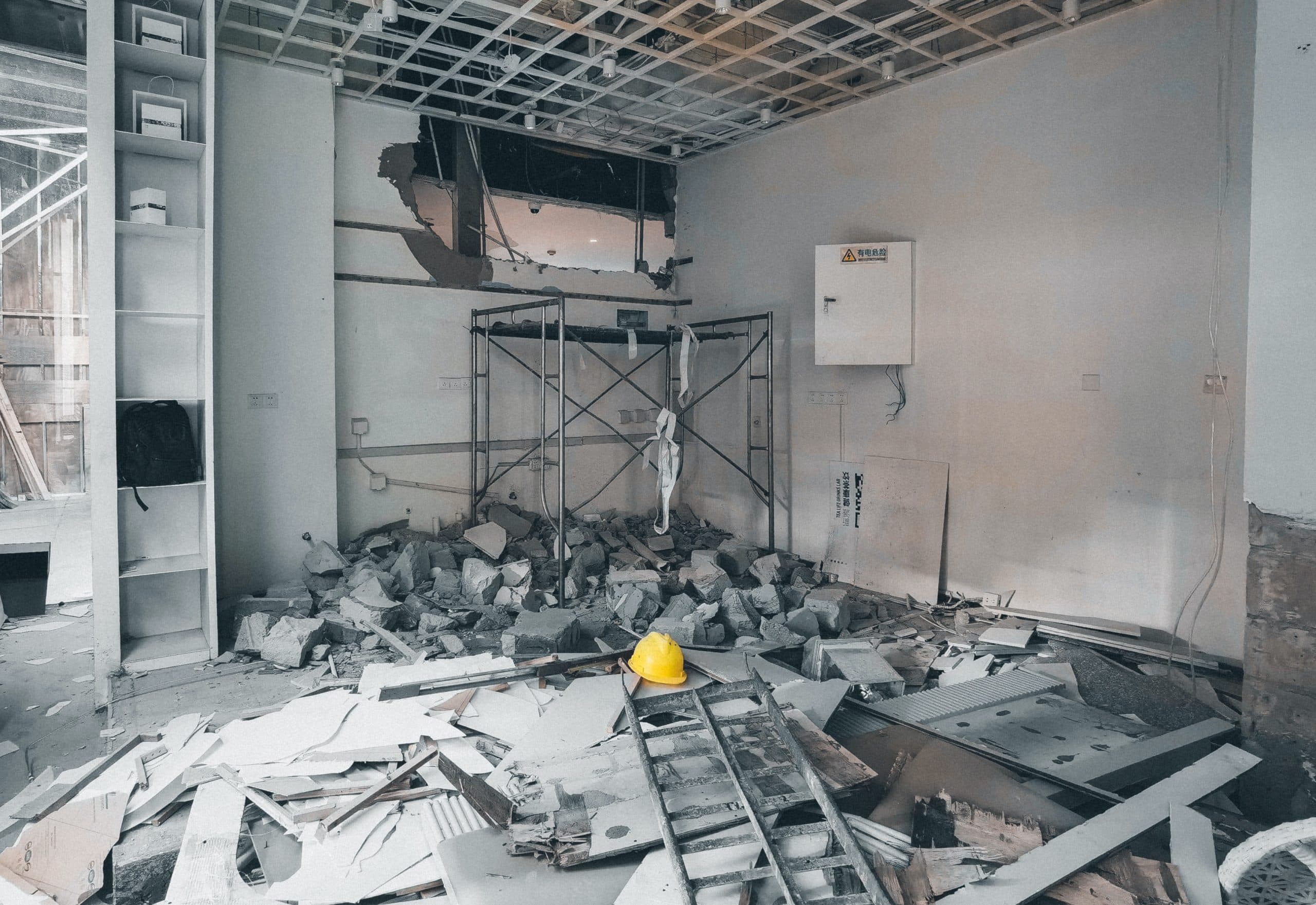 Photo of a building that has been partly demolished, showing a piece of construction workers